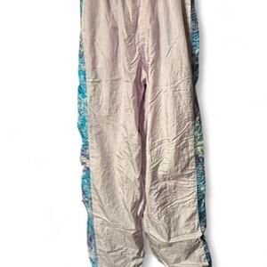 Small 80s retro light pink track pants with blue purple pink watercolor stripes,